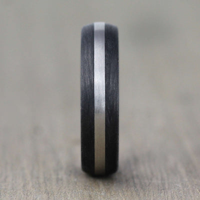 carbon fibre black wedding ring band with a palladium inlay. brushed finish 6mm wide court