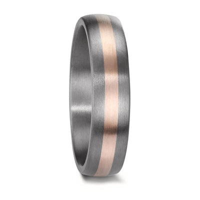 A matching wedding ring set crafted from tantalum and rose gold. The men's ring features a sleek, modern design with a central rose gold inlay, while the women's ring is adorned with three sparkling diamonds, complementing the warm rose gold accent set into the rich, dark tantalum