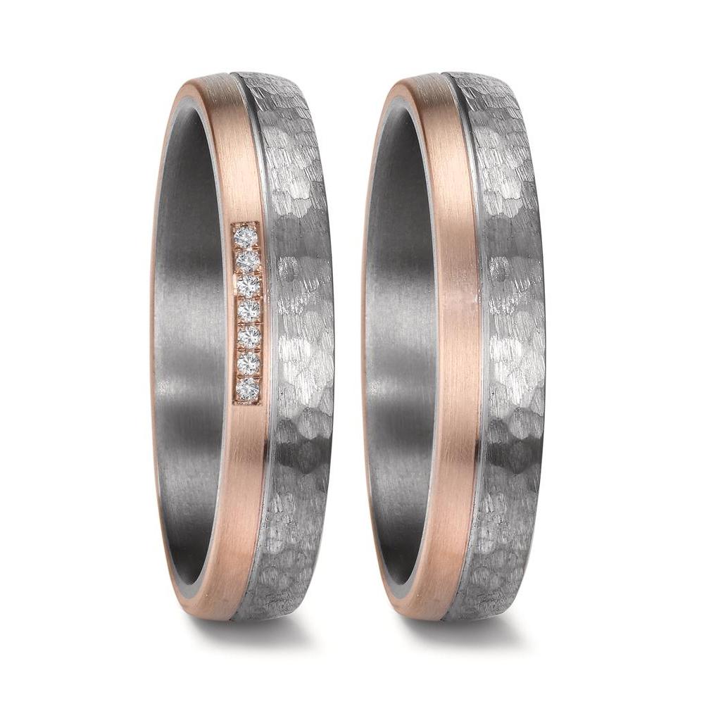Matching wedding ring set crafted from hammered tantalum and 14K rose gold. The men's ring features a rugged matte-finish hammered tantalum band with a brushed rose gold edge, while the women's ring mirrors the design and is adorned with seven sparkling diamonds set into the rose gold accent. Both rings are 4.5mm wide with a comfortable fit, blending modern elegance with unique textures