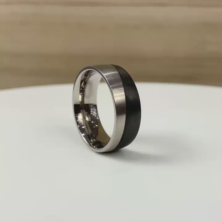 Titanium And Carbon fibre wedding ring band in a wave pattern. half black wedding band