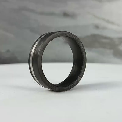 carbon fibre black wedding ring band with a palladium inlay. brushed finish 8mm wide flat court